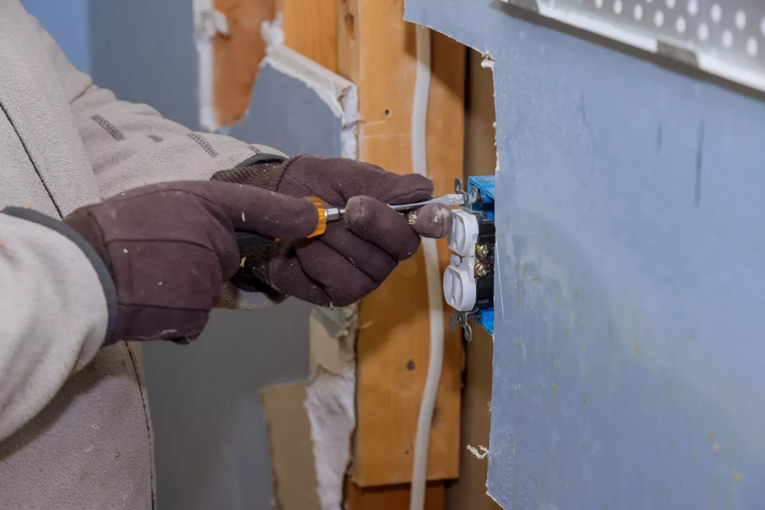 Preparing to remove an electrical outlet of the screws for electrical wires receptacle plug panel