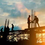 Silhouette of engineer and construction team working at site over blurred background sunset pastel for industry background with Light fair.