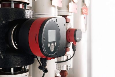 Smart circulator pump for residential and commercial heating or cooling. Used to adjust or changing settings or inspection of heating system. Plumbing or heating background. Selective focus.