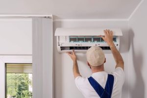Technician maintenance air conditioning open ac unit to checking filters in a living space. Service includes cleaning, replacement elements, ensuring optimal cooling and heating performance indoors