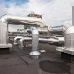 ventilators on the roof of a tall building in the industrial area