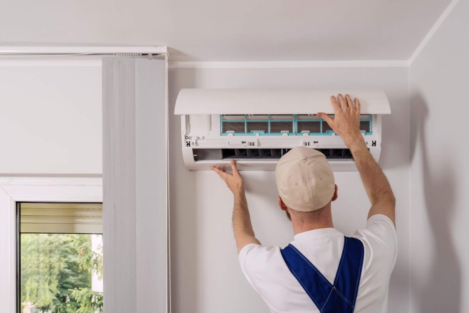 Technician maintenance air conditioning open ac unit to checking filters in a living space. Service includes cleaning, replacement elements, ensuring optimal cooling and heating performance indoors