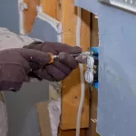 Preparing to remove an electrical outlet of the screws for electrical wires receptacle plug panel