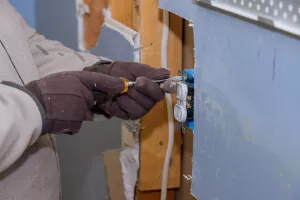 Preparing to remove an electrical outlet of the screws for electrical wires receptacle plug panel