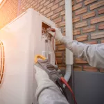 Air Conditioning Technician and A part of preparing to install new air conditioner. Technician vacuum pump evacuates and checking new air conditioner