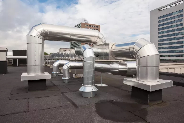 ventilators on the roof of a tall building in the industrial area