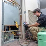 Checking refrigerant charge on a heat pump, wearing a safety mask and glasses