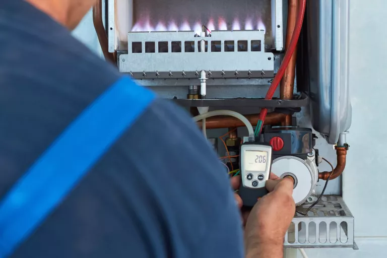 Repair of a gas boiler, setting up and servicing by a service department. Adjustment of gas pressure by manometer
